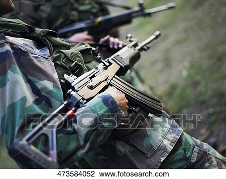 Mid section view of two army soldiers holding machine guns View Large Photo Image Stock Image - Mid section view of two army soldiers holding machine guns. Fotosearch