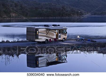 Mobile home parked at the riverside View Large Photo Image Stock Image - Mobile home parked at the riverside. Fotosearch