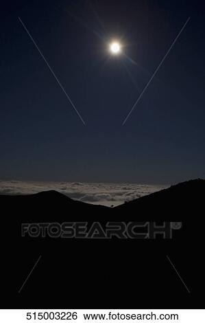 Stock Photograph - Moon over mountain range, Mauna Kea, Big Island, Hawaii, USA. Fotosearch