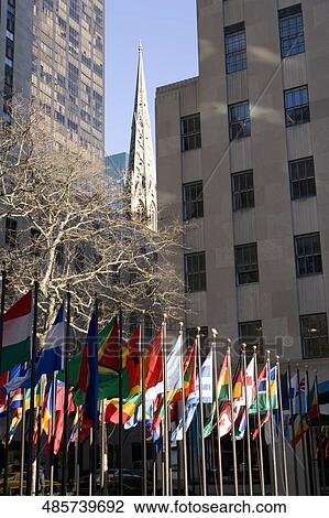 Stock Image - National Flags of various countries in front of a building, Rockefeller Center, Manhattan, New York City, New York State, USA. Fotosearch