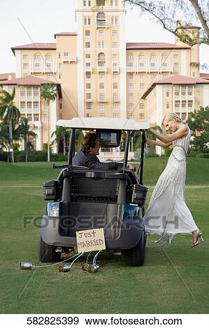 Stock Photo - Newlywed couple in a golf cart, Biltmore Golf Course, Biltmore Hotel, Coral Gables, Florida, USA. Fotosearch