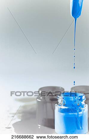 Stock Image - Paint dripping from a paintbrush. Fotosearch