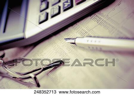 Pen with a calculator and eyeglasses on a financial newspaper View Large Photo Image Stock Image - Pen with a calculator and eyeglasses on a financial newspaper. Fotosearch