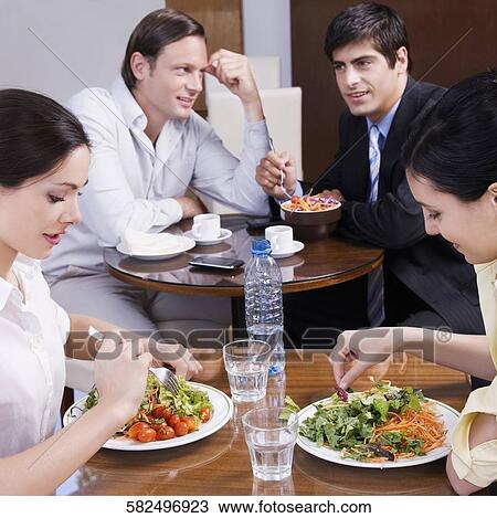 People dining in a restaurant View Large Photo Image Stock Image - People dining in a restaurant. Fotosearch