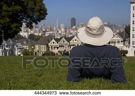 Person in a park with a row of Victorian style houses in the background, Alamo Square, Painted Ladies, San Francisco, California, USA View Large Photo Image Stock Image - Person in a park with a row of Victorian style houses in the background, Alamo Square, Painted Ladies, San Francisco, California, USA. Fotosearch