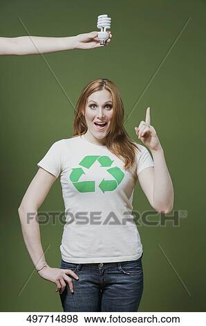 Stock Photo - Person's hand holding a light bulb above a woman's head. Fotosearch