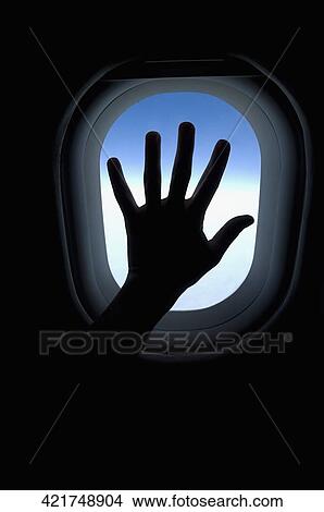 Person's hand in front of an airplane window View Large Photo Image Picture - Person's hand in front of an airplane window. Fotosearch