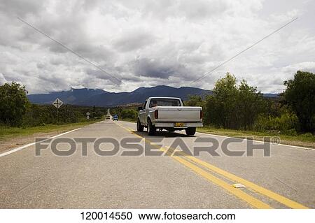 Stock Image - Pick-up truck on the road. Fotosearch