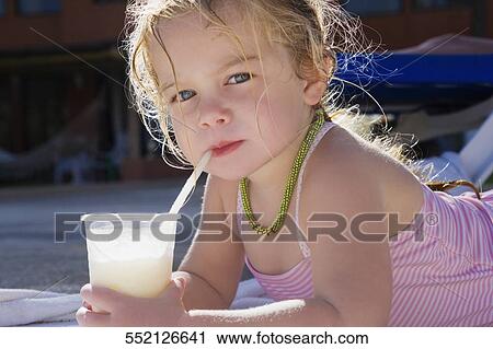 Portrait of a baby girl drinking juice with a straw View Large Photo Image Stock Image - Portrait of a baby girl drinking juice with a straw. Fotosearch