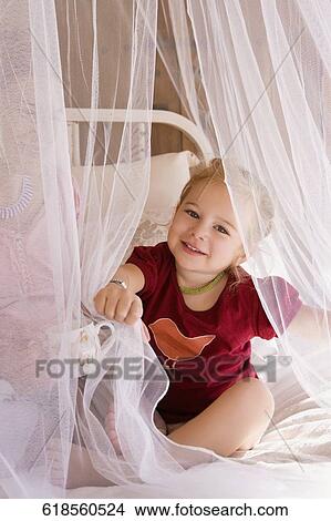Portrait of a baby girl sitting with her mother View Large Photo Image Picture - Portrait of a baby girl sitting with her mother. Fotosearch