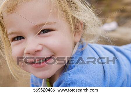 Stock Photography - Portrait of a baby girl smiling. Fotosearch