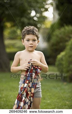Portrait of a boy holding a towel View Large Photo Image Stock Photograph - Portrait of a boy holding a towel. Fotosearch