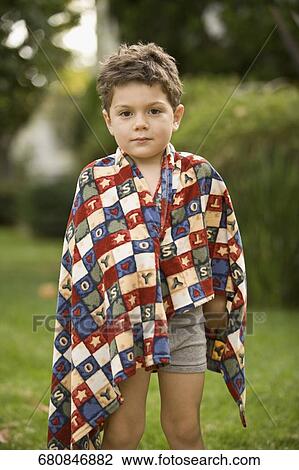 Stock Image - Portrait of a boy wrapped in a towel. Fotosearch