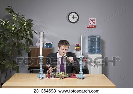 Portrait of a businessman having lunch in the office View Large Photo Image Stock Photo - Portrait of a businessman having lunch in the office. Fotosearch