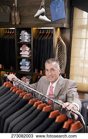 Portrait of a businessman in a clothing store View Large Photo Image Stock Image - Portrait of a businessman in a clothing store. Fotosearch