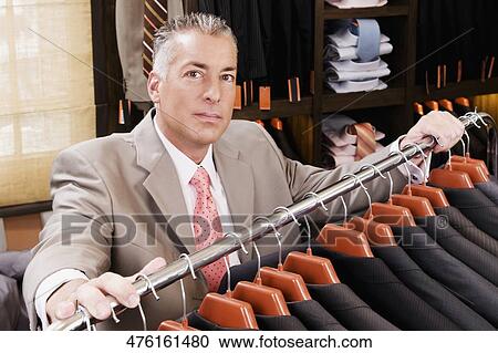 Portrait of a businessman in a clothing store View Large Photo Image Stock Image - Portrait of a businessman in a clothing store. Fotosearch