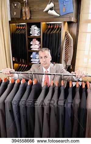 Portrait of a businessman in a clothing store View Large Photo Image Stock Photograph - Portrait of a businessman in a clothing store. Fotosearch