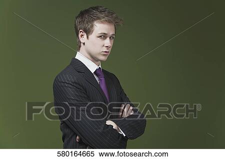 Stock Photography - Portrait of a businessman with his arms crossed. Fotosearch