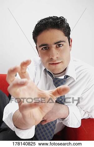 Portrait of a businessman with his hand out View Large Photo Image Stock Photography - Portrait of a businessman with his hand out. Fotosearch