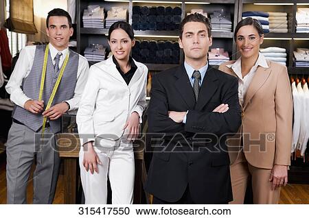 Portrait of a businessman with two saleswomen and a tailor in a store View Large Photo Image Stock Image - Portrait of a businessman with two saleswomen and a tailor in a store. Fotosearch