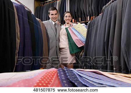 Portrait of a couple shopping in a clothing store View Large Photo Image Stock Photography - Portrait of a couple shopping in a clothing store. Fotosearch