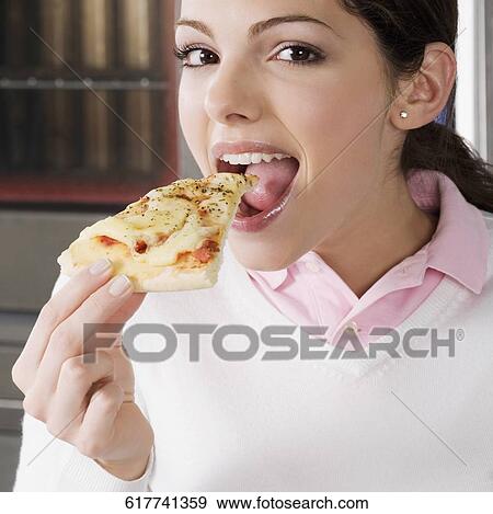 Portrait of a female chef eating a slice of pizza View Large Photo Image Stock Photo - Portrait of a female chef eating a slice of pizza. Fotosearch