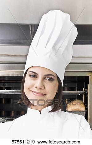 Stock Photo - Portrait of a female chef smiling. Fotosearch