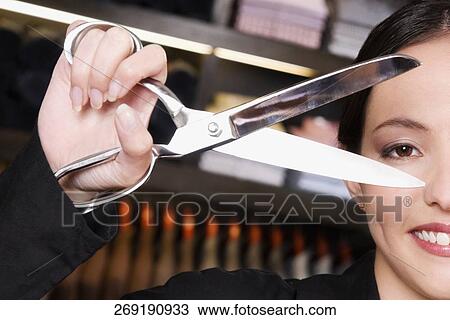 Portrait of a female tailor holding scissors View Large Photo Image Stock Image - Portrait of a female tailor holding scissors. Fotosearch