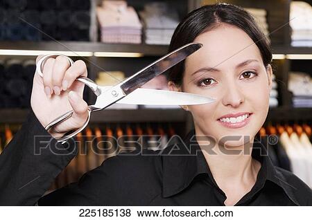 Portrait of a female tailor holding scissors View Large Photo Image Stock Photo - Portrait of a female tailor holding scissors. Fotosearch