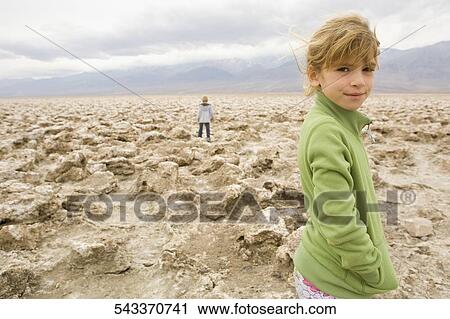 Portrait of a girl standing in a desert View Large Photo Image Stock Image - Portrait of a girl standing in a desert. Fotosearch
