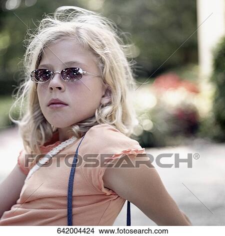 Portrait of a girl wearing sunglasses View Large Photo Image Picture - Portrait of a girl wearing sunglasses. Fotosearch