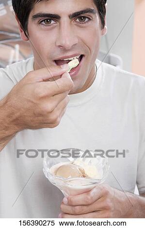 Portrait of a man eating an ice cream View Large Photo Image Stock Photography - Portrait of a man eating an ice cream. Fotosearch