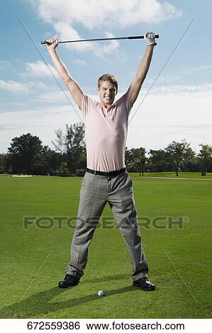 Stock Photograph - Portrait of a man holding a golf club in a golf course, Biltmore Golf Course, Coral Gables, Florida, USA. Fotosearch