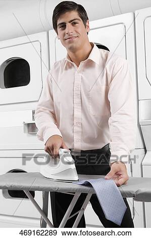 Portrait of a man ironing a tie View Large Photo Image Stock Photo - Portrait of a man ironing a tie. Fotosearch