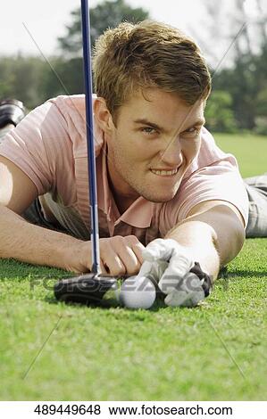 Portrait of a man playing golf in a golf course, Biltmore Golf Course, Coral Gables, Florida, USA View Large Photo Image Stock Photo - Portrait of a man playing golf in a golf course, Biltmore Golf Course, Coral Gables, Florida, USA. Fotosearch