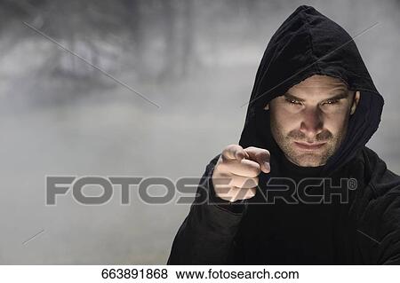 Stock Photo - Portrait of a man pointing with his finger, Mammoth Hot Springs, Yellowstone National Park, Wyoming, USA. Fotosearch