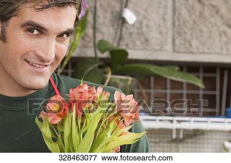 Portrait of a man smiling in greenhouse View Large Photo Image Stock Photo - Portrait of a man smiling in greenhouse. Fotosearch