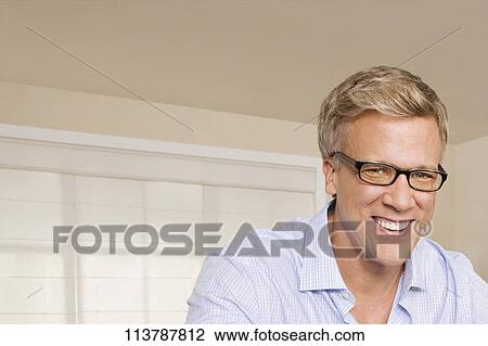 Stock Image - Portrait of a man smiling. Fotosearch
