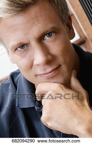 Stock Image - Portrait of a man thinking. Fotosearch