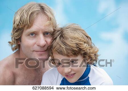 Portrait of a man with his son at the poolside View Large Photo Image Picture - Portrait of a man with his son at the poolside. Fotosearch