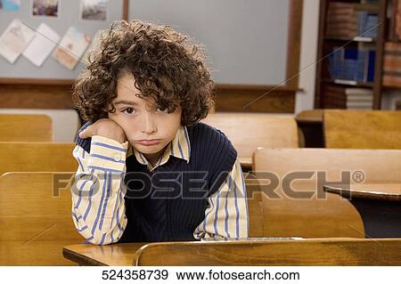 Stock Photo - Portrait of a schoolboy in a classroom. Fotosearch