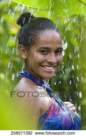 Stock Image - Portrait of a teenage girl enjoying shower. Fotosearch