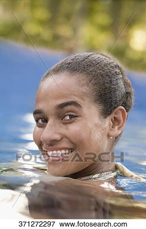 Portrait of a teenage girl smiling in a swimming pool View Large Photo Image Stock Photo - Portrait of a teenage girl smiling in a swimming pool. Fotosearch