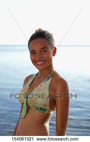Portrait of a teenage girl smiling on the beach View Large Photo Image Stock Image - Portrait of a teenage girl smiling on the beach. Fotosearch