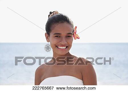 Portrait of a teenage girl smiling on the beach View Large Photo Image Stock Photo - Portrait of a teenage girl smiling on the beach. Fotosearch