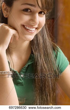 Stock Image - Portrait of a teenage girl smiling. Fotosearch