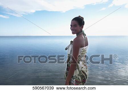 Stock Photo - Portrait of a teenage girl standing on the beach. Fotosearch