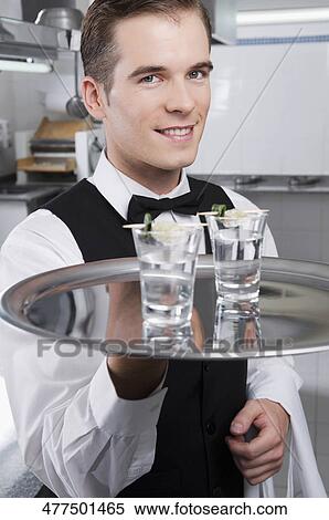 Portrait of a waiter holding a tray of tequila shots View Large Photo Image Stock Photography - Portrait of a waiter holding a tray of tequila shots. Fotosearch