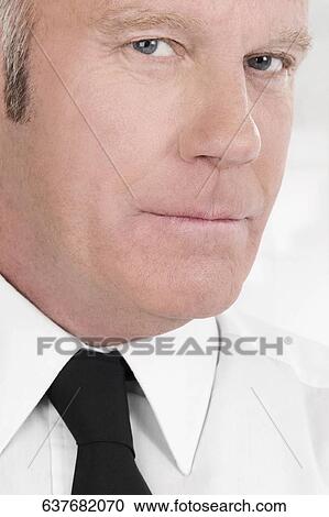Portrait of a waiter looking serious View Large Photo Image Stock Image - Portrait of a waiter looking serious. Fotosearch