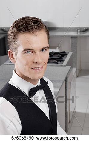 Portrait of a waiter smiling View Large Photo Image Stock Image - Portrait of a waiter smiling. Fotosearch